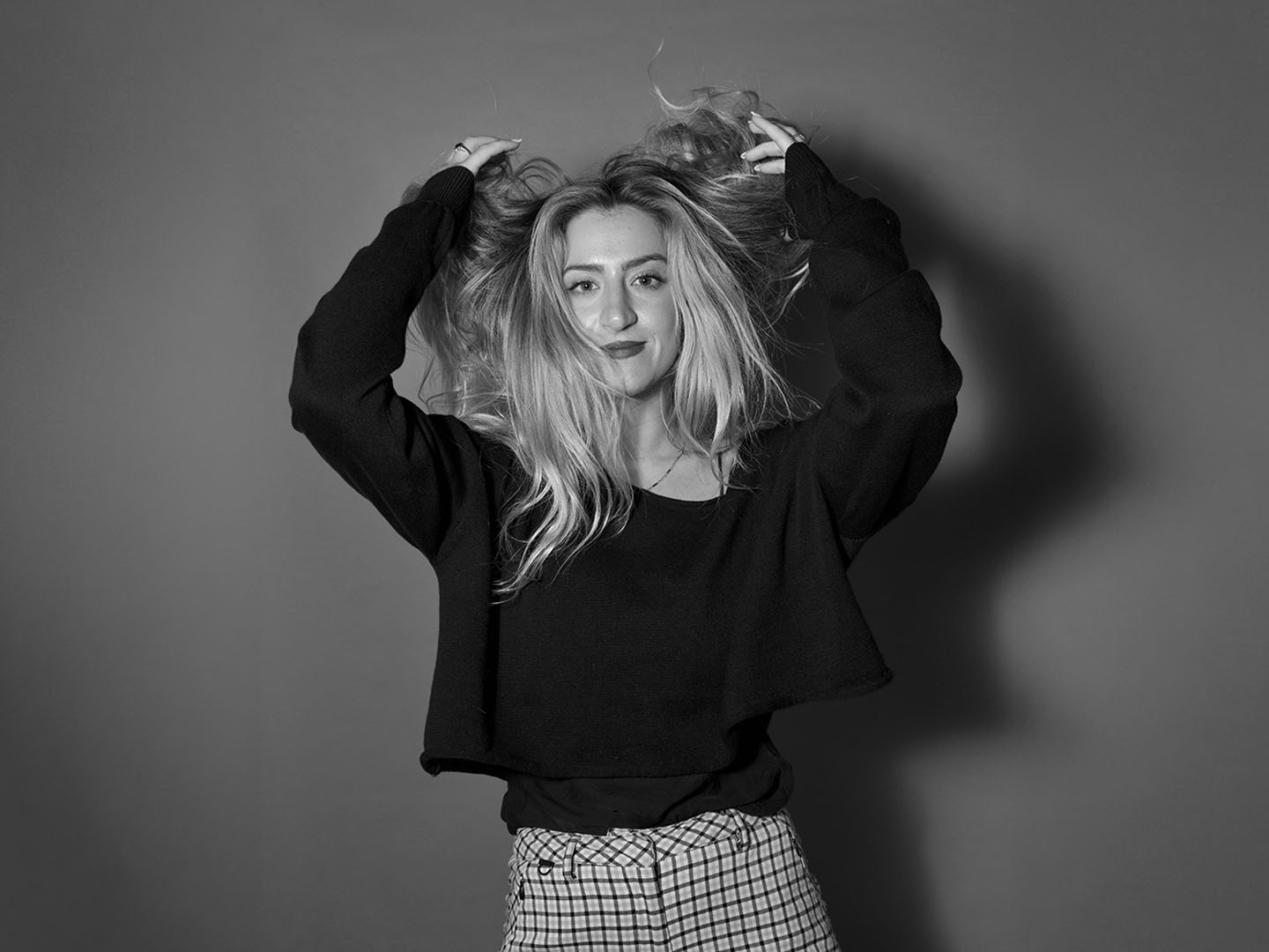 Shani Able, black and white portrait with hands in her hair